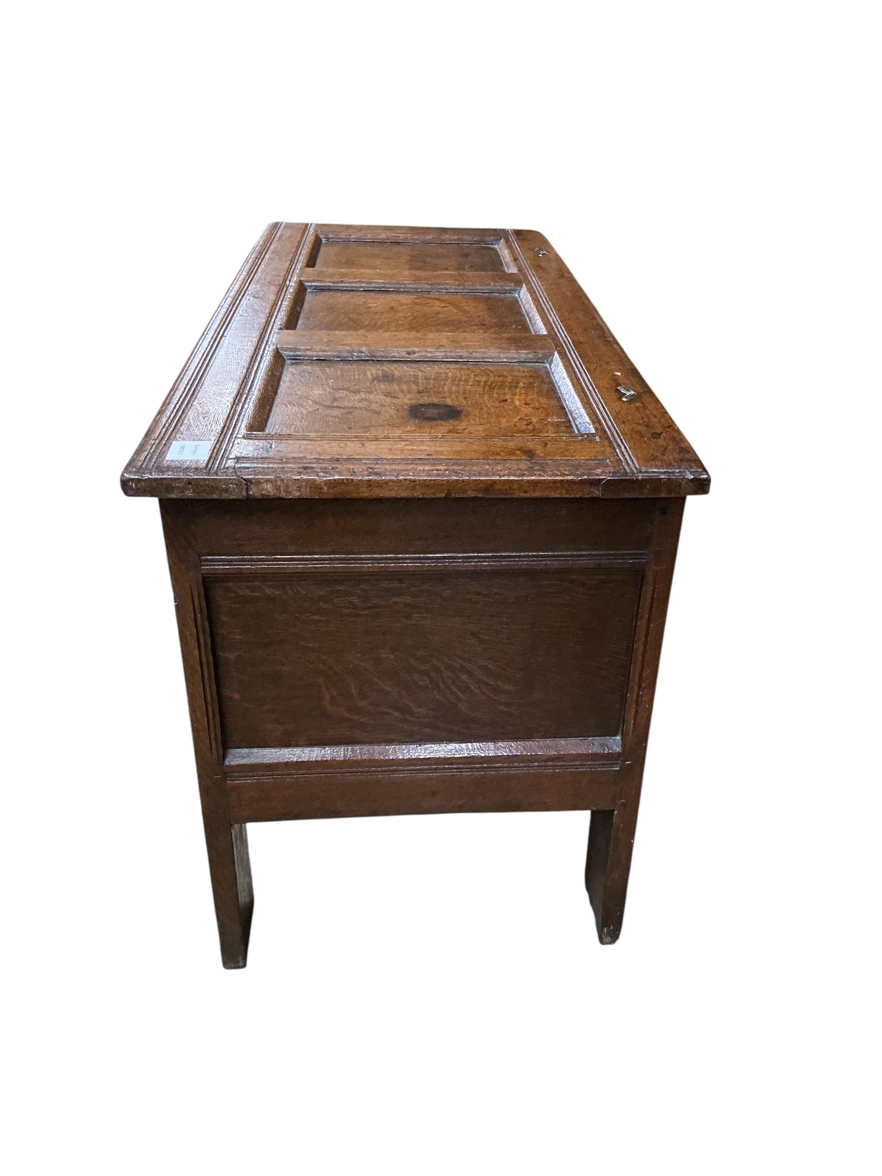 An oak coffer with three panels carved with roundels, width 106cm, depth 47cm, height 61cm
